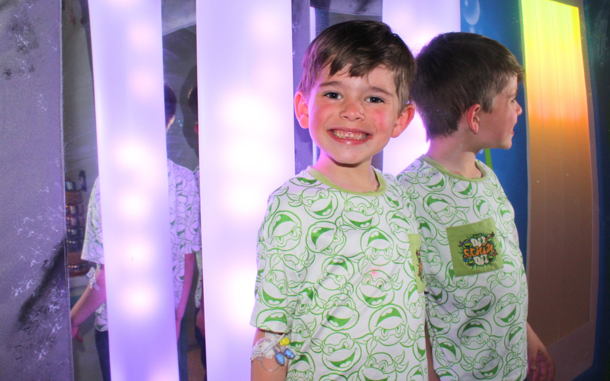 Young patient smiling as they play in the sensory room at Warrington Hospital.