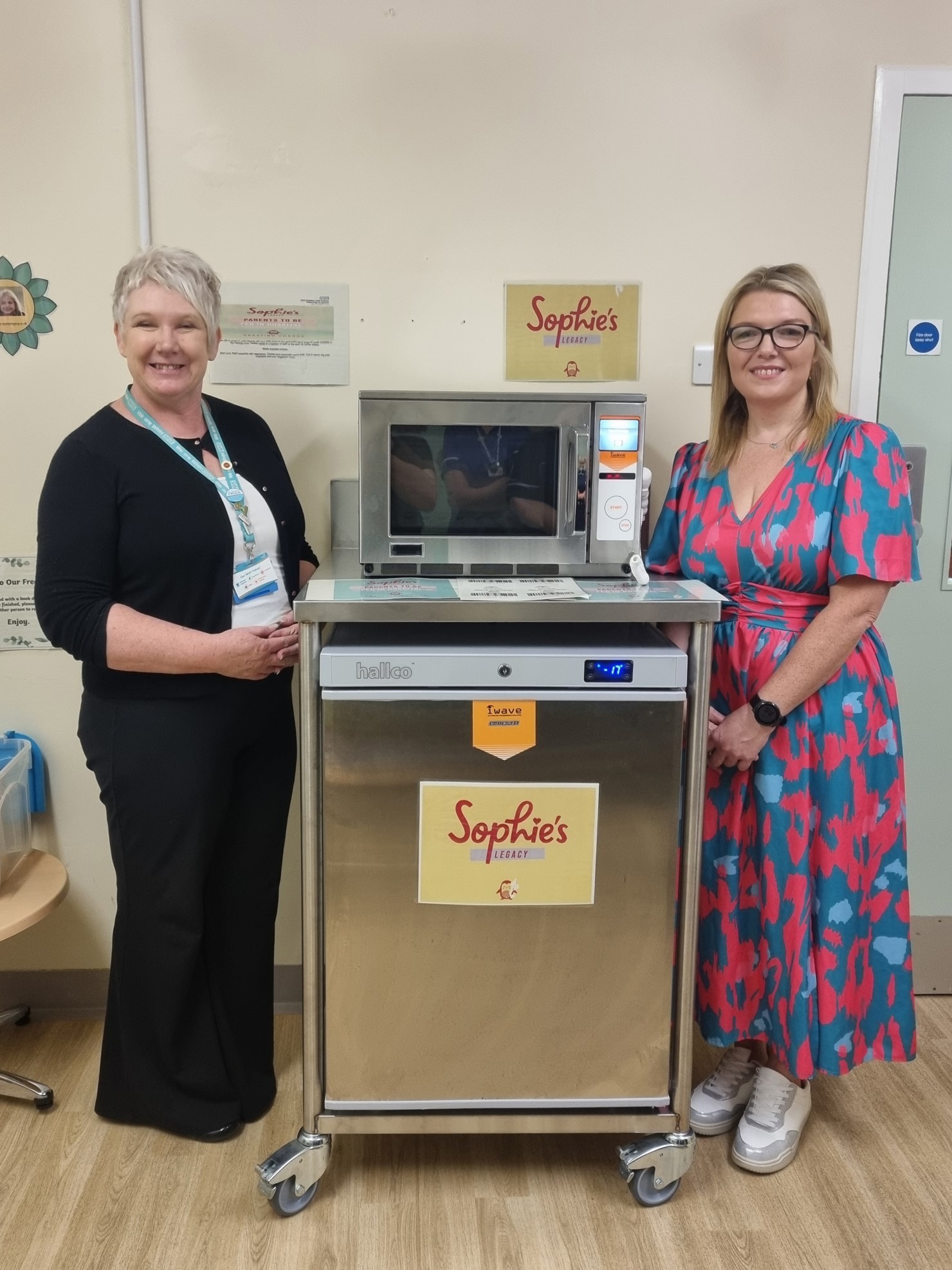 Founder and CEO of Sophie’s Legacy and WHH Charity's head of fundraising with microwave and fridge.