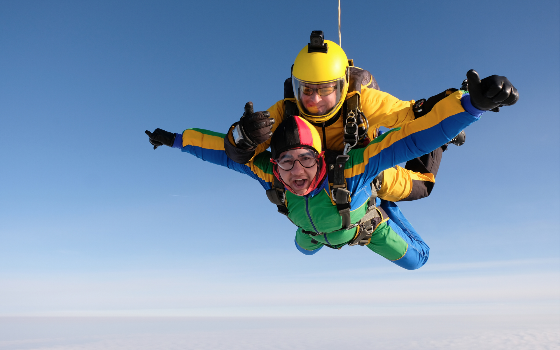 Two people mid-air skydiving.