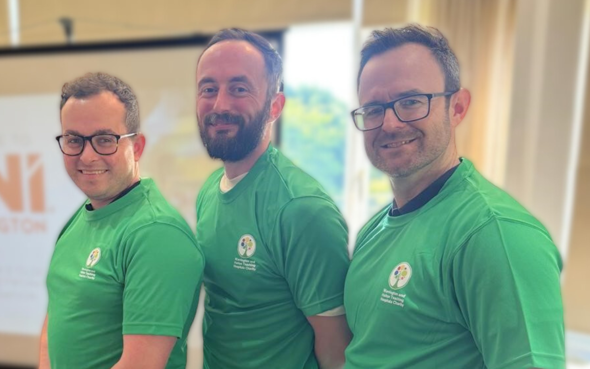 Three male fundraisers wearing green WHH Charity T-shirts.