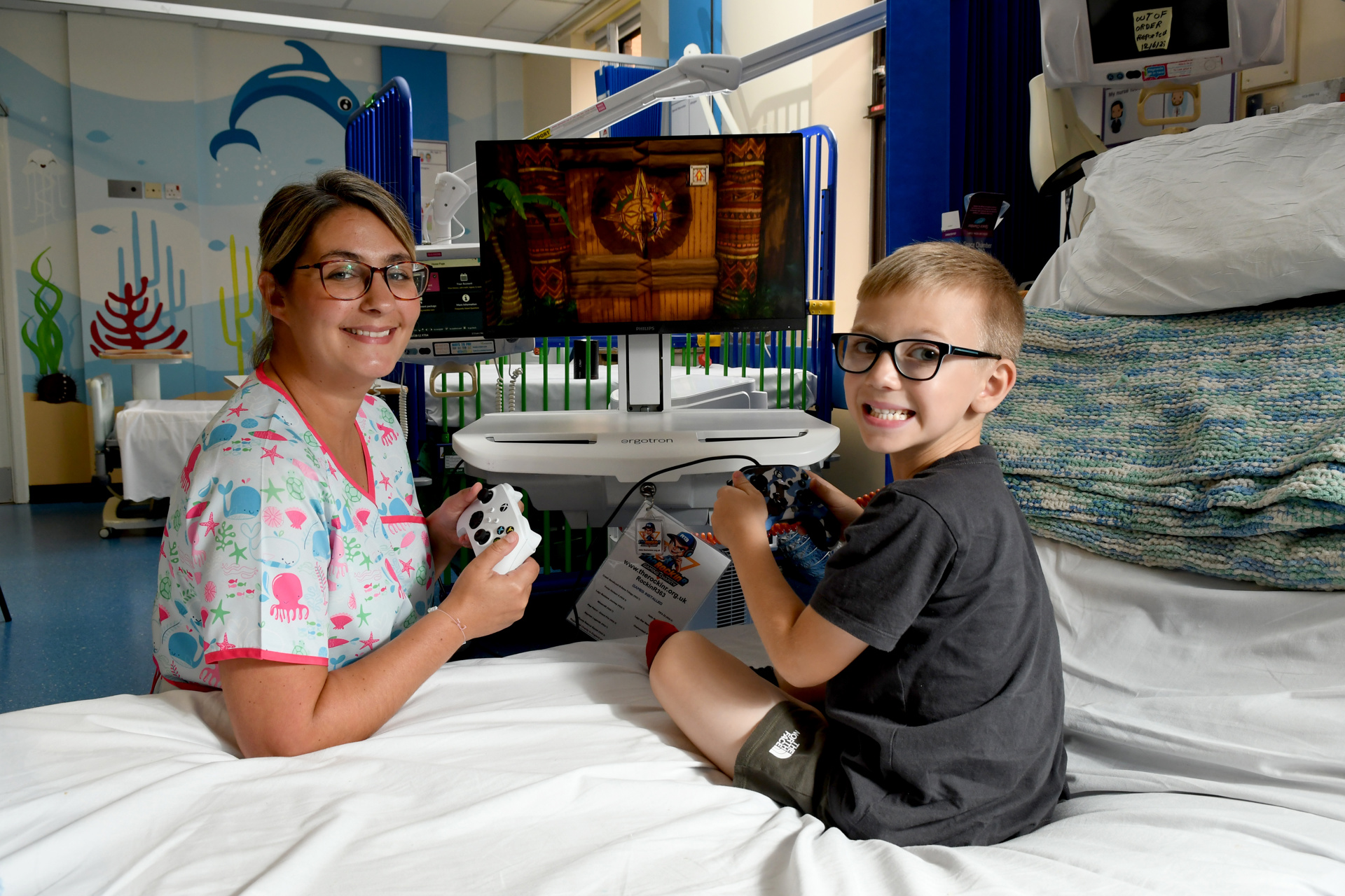Play specialist and young patients using donated gaming station.
